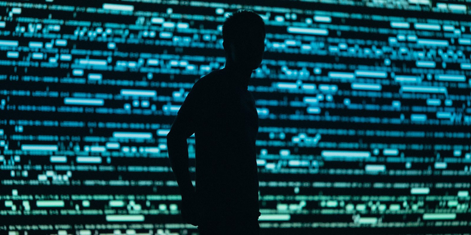 India orders Apple to pre-instal an undeletable state security app on iPhones | Photo shows the silhouette of a person against a background representing data