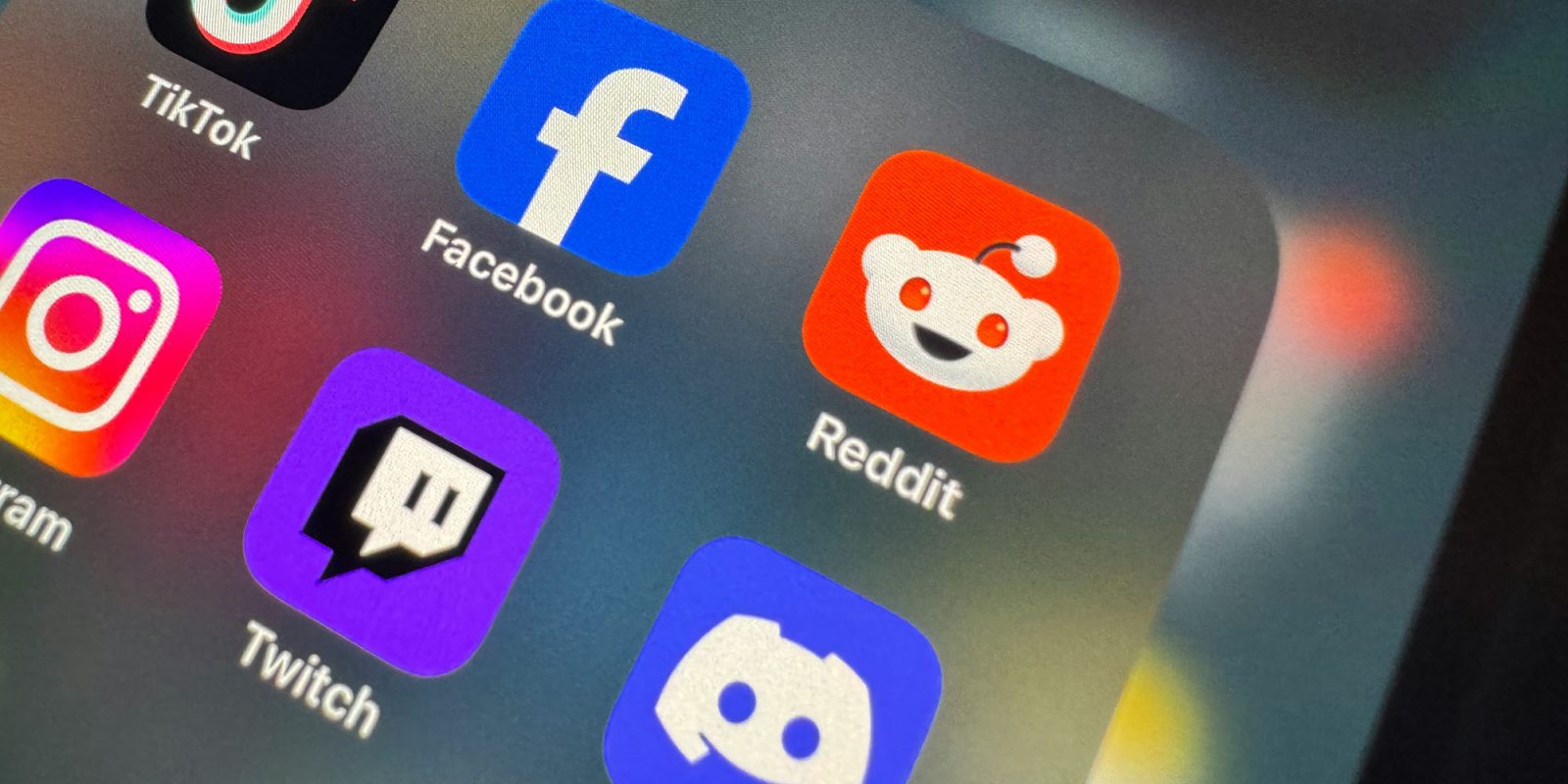 Reddit and Discord are both in trouble over controversial age verification service | App icons seen on an iPhone screen