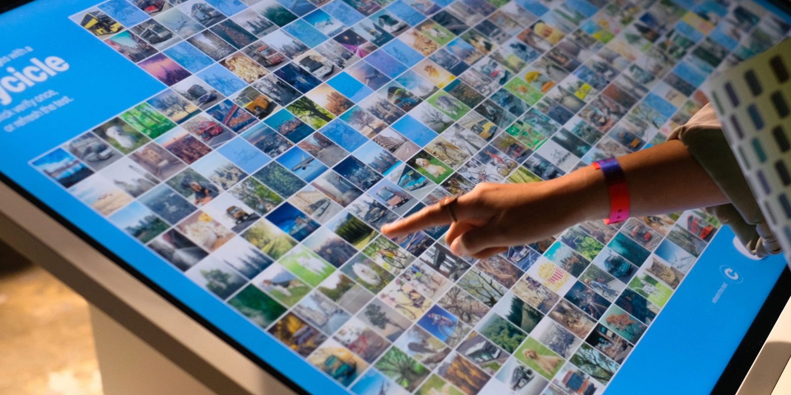 With this report, I'm no longer scared of a touchscreen Mac | Stock image of somebody using a large touchscreen