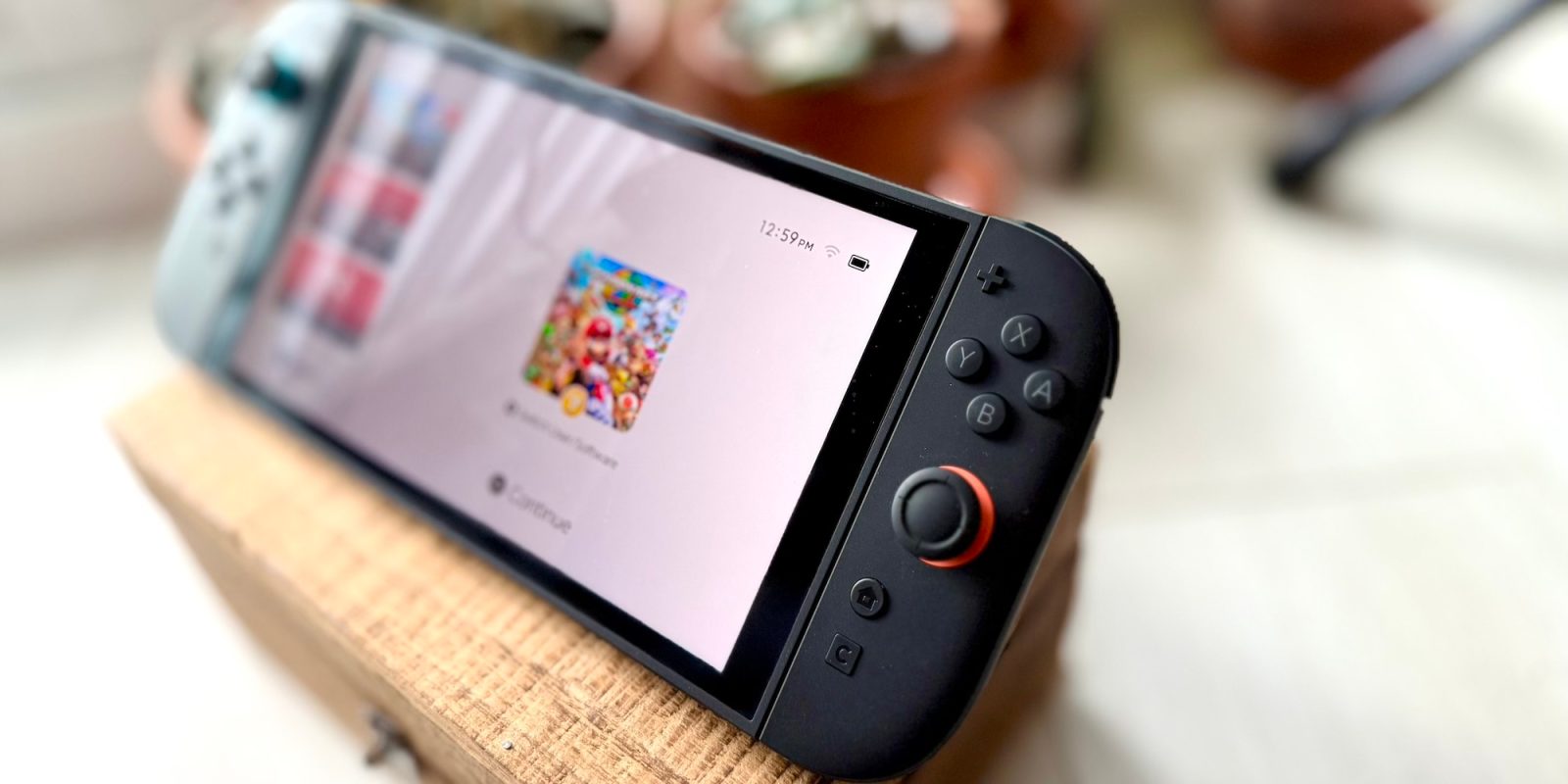 A black gaming device with buttons and a white screen