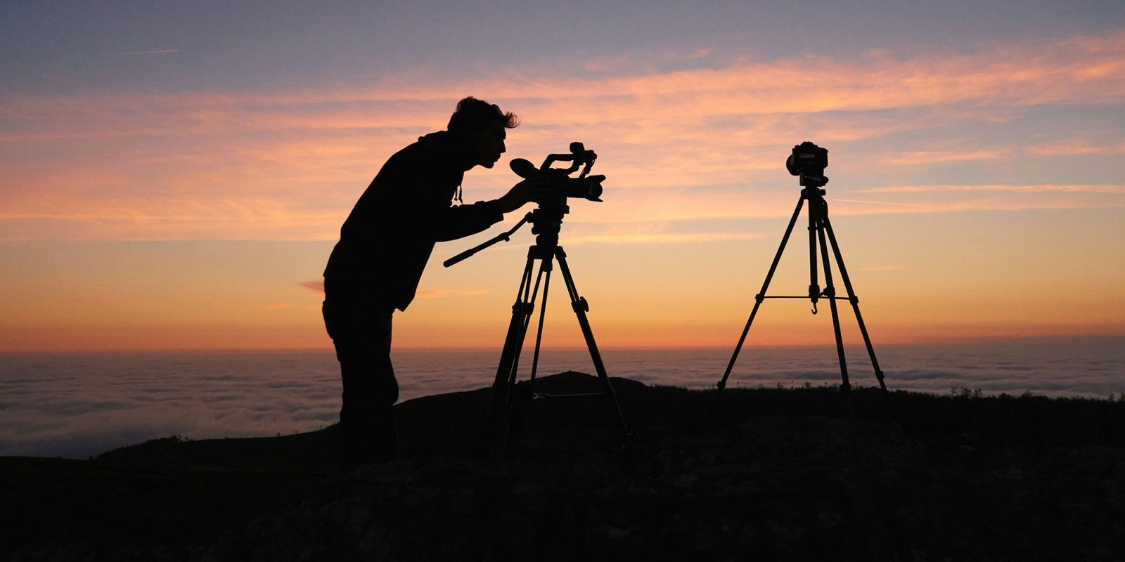 Videographers obviously shouldn't buy the MacBook Neo, but neither should photographers | Silhouette of a photographer on a hillside against a sunset