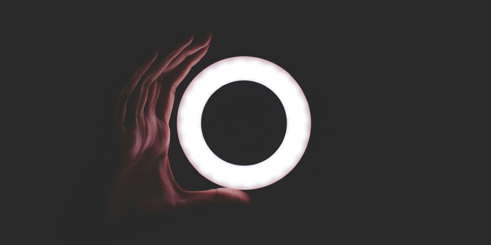 iPhone Diary: The camera let me shoot video in near-impossible conditions | Photo shows a hand with a small ring light in the pitch black