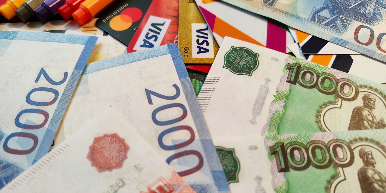 Apple pulls the plug on all payments in Russia following government diktat | Photo shows Russian banknotes and credit cards