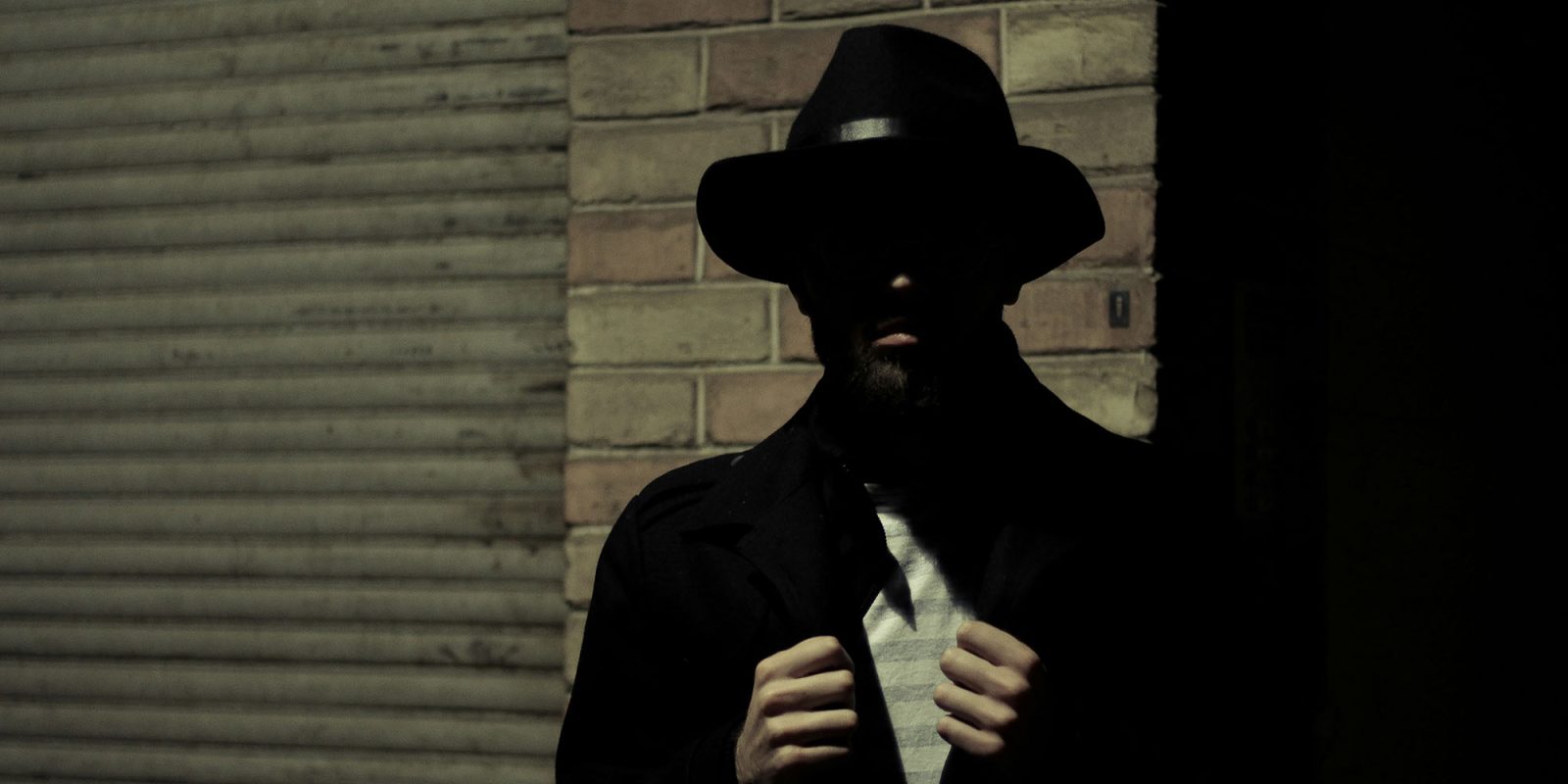 Judge blocks White House from 'strong-arming' Apple into blocking ICE trackers | Stock photo shows a shadowy figure representing the mob