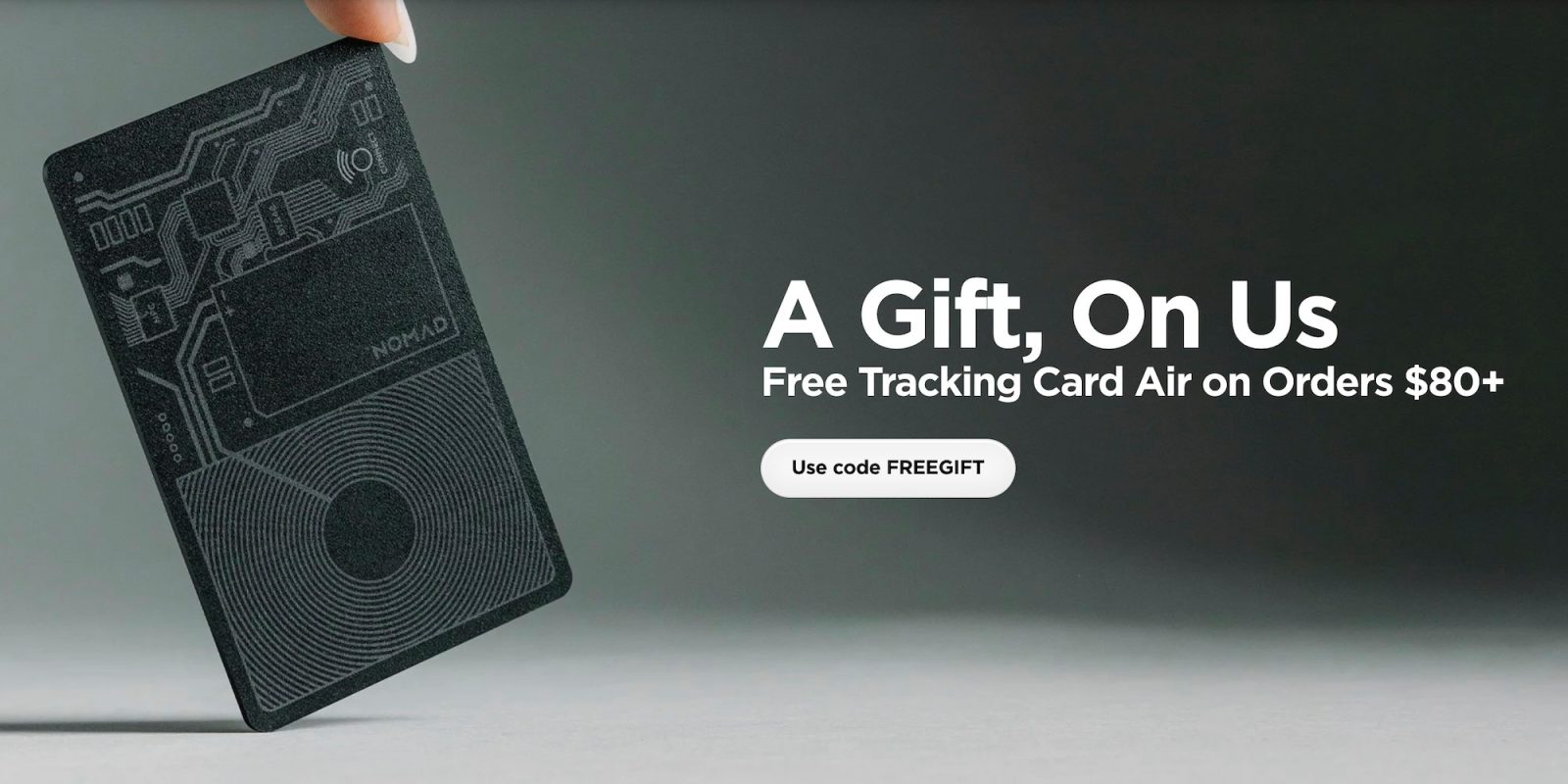 A hand holding a black rectangular object