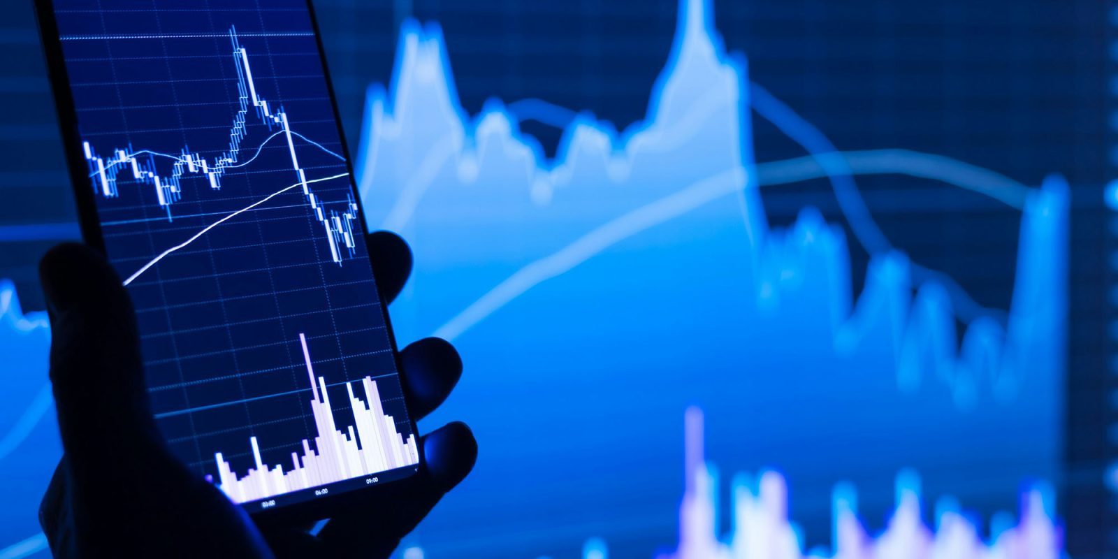 Smartphone market down and worsening, but Apple's tactic pays off – IDC | Stock photo shows graphs displayed on smartphone and PC screens