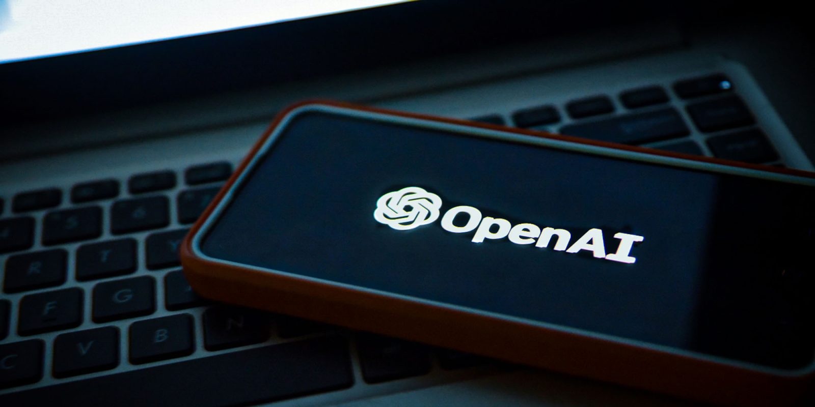 A security breach means you must update the ChatGPT Mac app | Photo shows the OpenAI logo on a phone sitting on a laptop