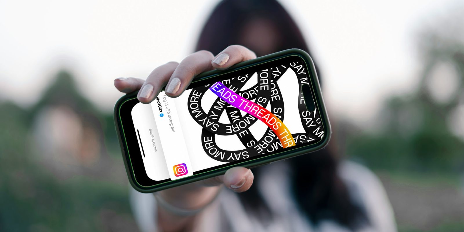 Most Americans would ban social media for under-16s, with parents the most vocal | Photo shows a girl holding an iPhone with the Threads logo