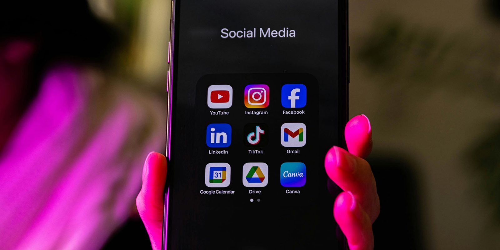 Unprecedented teen protections on Instagram see $18B lawsuit settled | Photo shows a hand holding an iPhone with social media apps in a folder