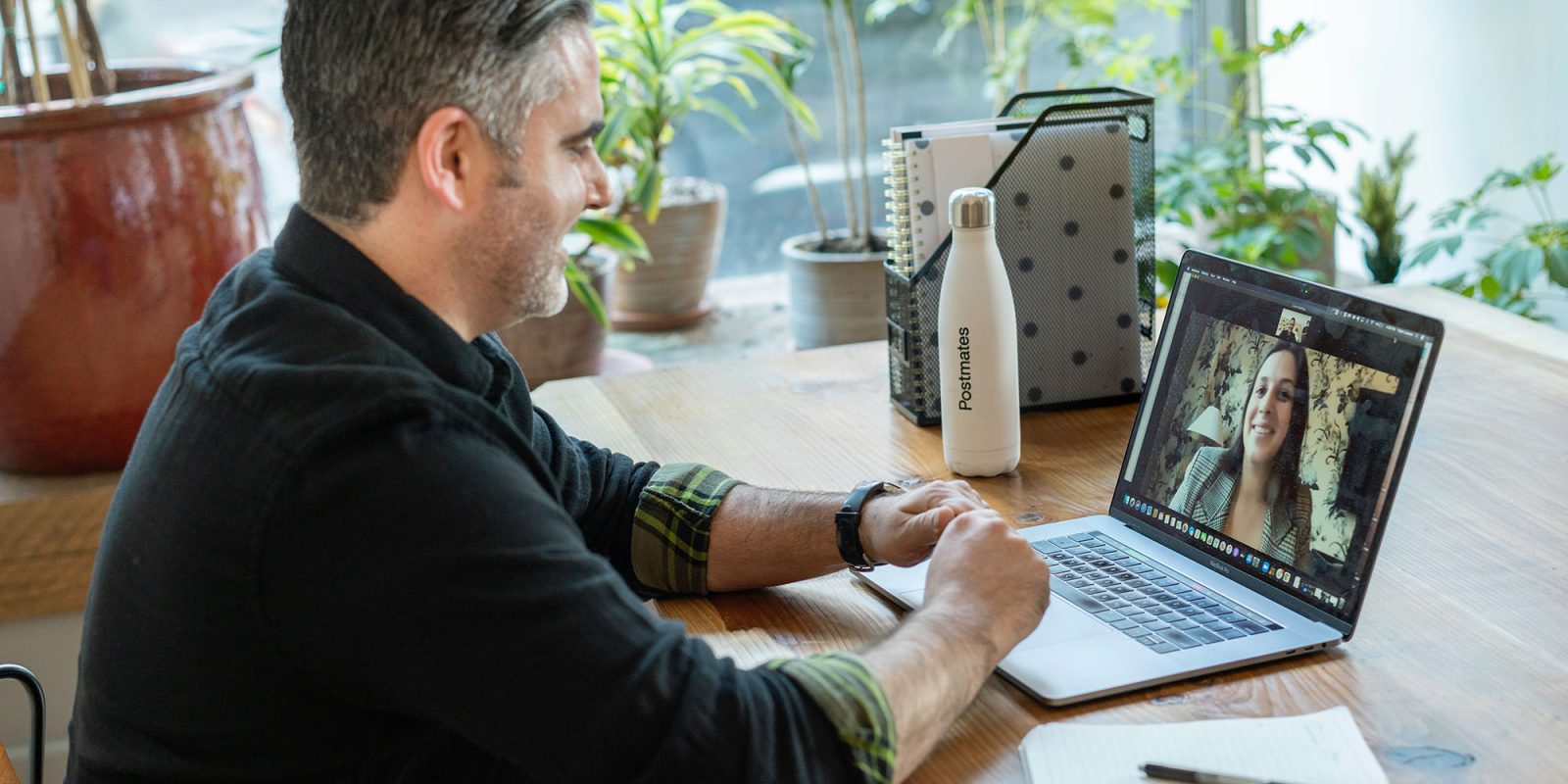 Zoom flaw let an attacker take over your device, including iPhone and Mac | Stock photo of a man on a video call using a MacBook