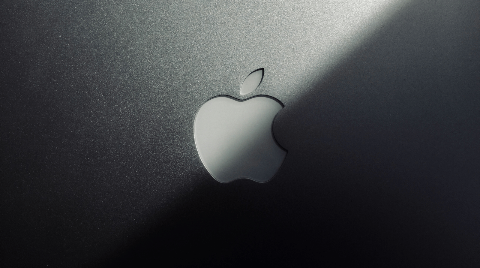 top of a MacBook lid showing the Apple logo