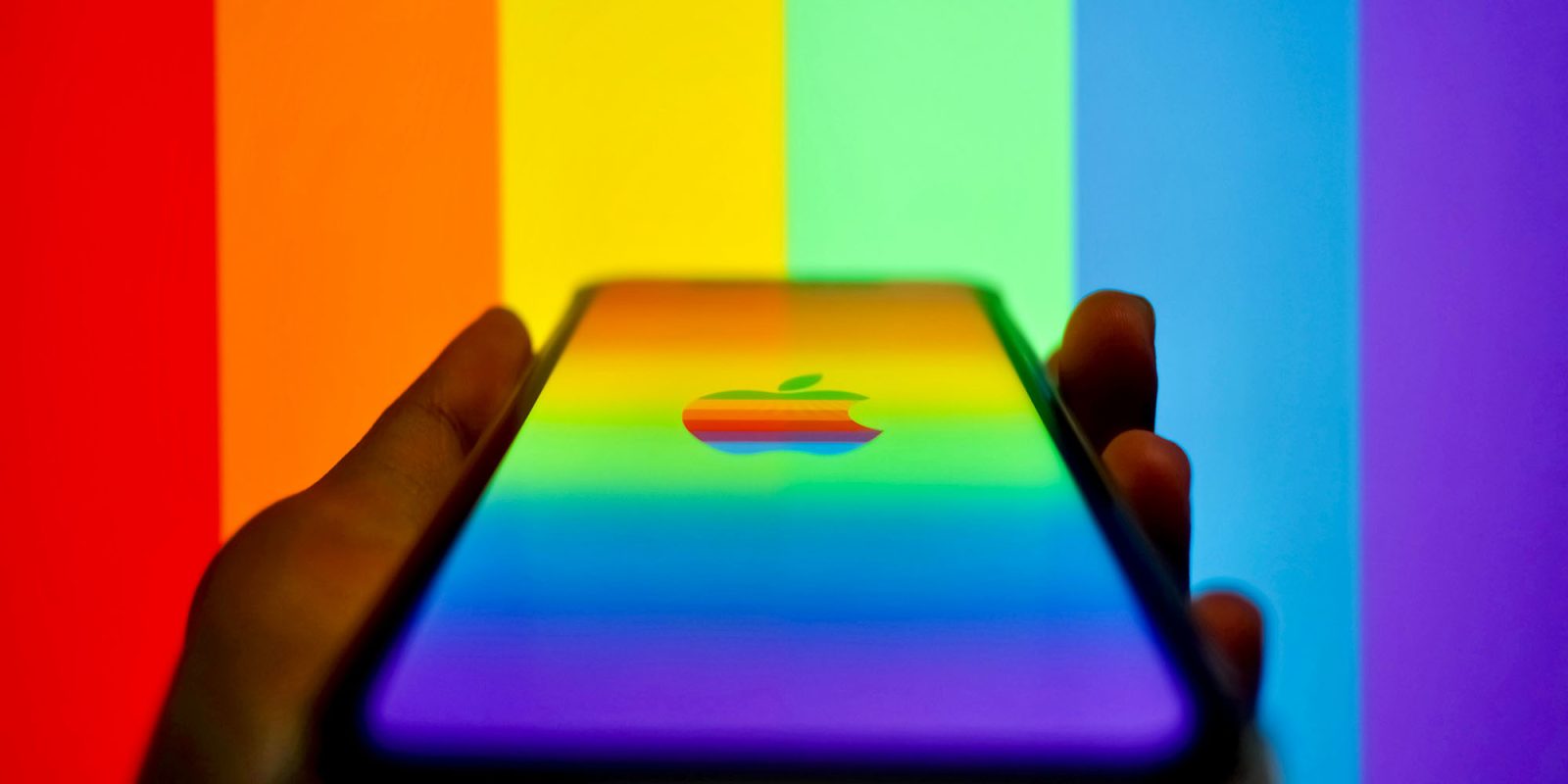 Apple's long-running app store battle with the EU appears to finally be over | iPhone with Apple rainbow logo and stripes