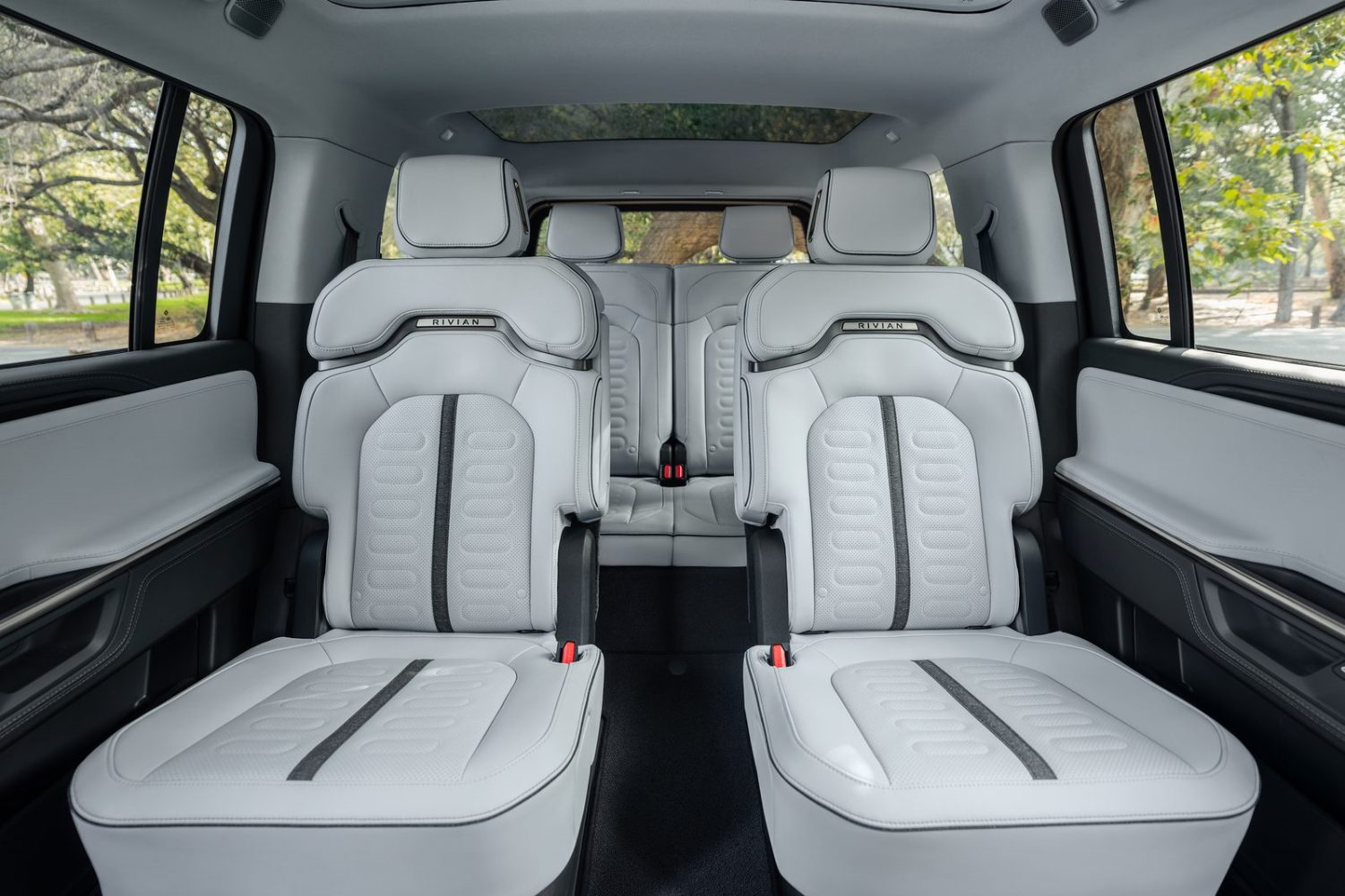 2027 Rivian R1S second-row captain's chairs in a light interior