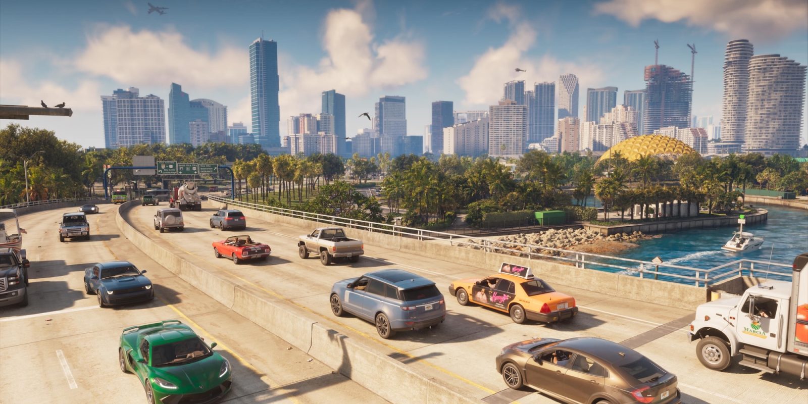 A group of cars on a highway with a city in the background
