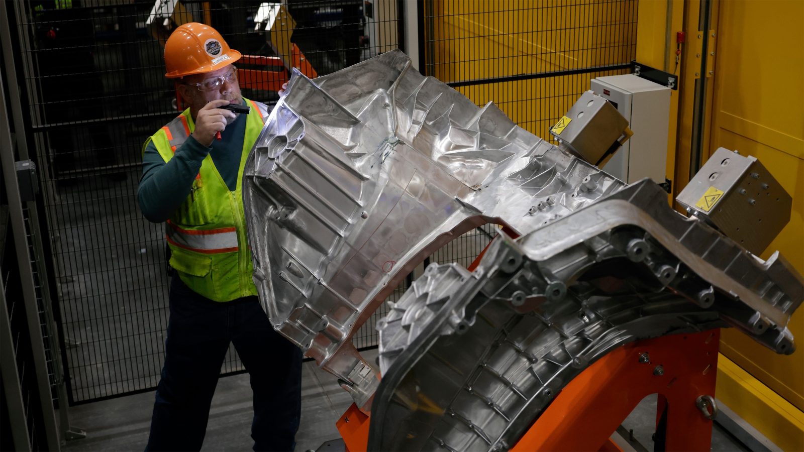 Ford worker inspecting a Fathom aluminum unicasting