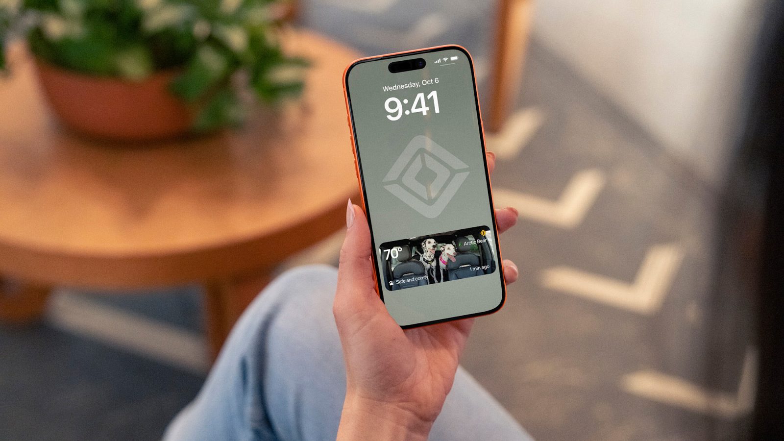 Rivian Pet Cam snapshot on a phone lock screen showing two dogs in an R2